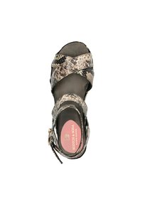 Black and grey snake print sandal featuring crisscross straps, adjustable ankle buckle, flat sole, and pink branding on the insole.