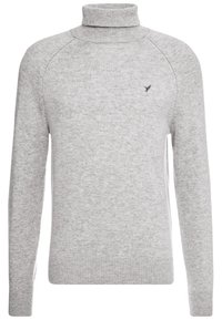 Pull en tricot à col roulé à manches longues gris clair avec des poignets et un ourlet côtelés, orné d'un petit logo d'oiseau brodé sur la poitrine gauche.
