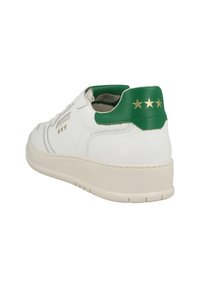 White sneakers with a textured leather upper, green heel tab, and gold star accents. Features a thick white sole for support.