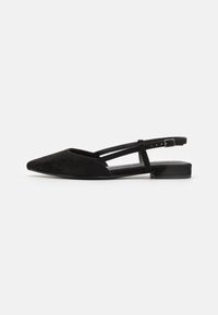 Black suede slingback flats with a pointed toe, open sides, and a flat heel. Adjustable ankle strap features a metal buckle detail.