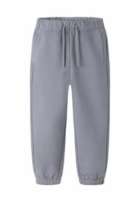 Lys grå sweatpants lavet af blødt stof, med elastisk talje, sidelommer og tætsiddende stolper for en snug pasform.