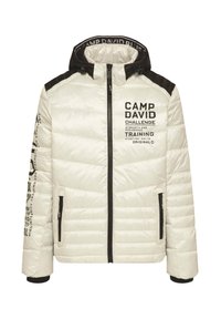 White quilted hooded jacket with black shoulder panels, black zipper, side pockets, and printed "Camp David Challenge Training" text on chest and sleeve.