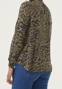 Langærmet bluse med leopardprint i tan og mørkebrun med rund hals, der har en nøglehulselås bagpå og let buet sømkant.
