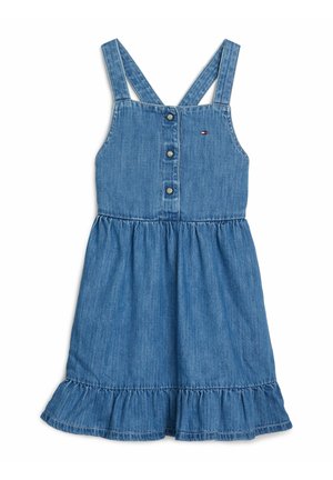 Spijkerjurk met verstelbare spaghetti bandjes, knopen aan de voorkant en een uitlopende gerafelde zoom. Lichtblauwe kleur, met subtiel logodetail op de borst.