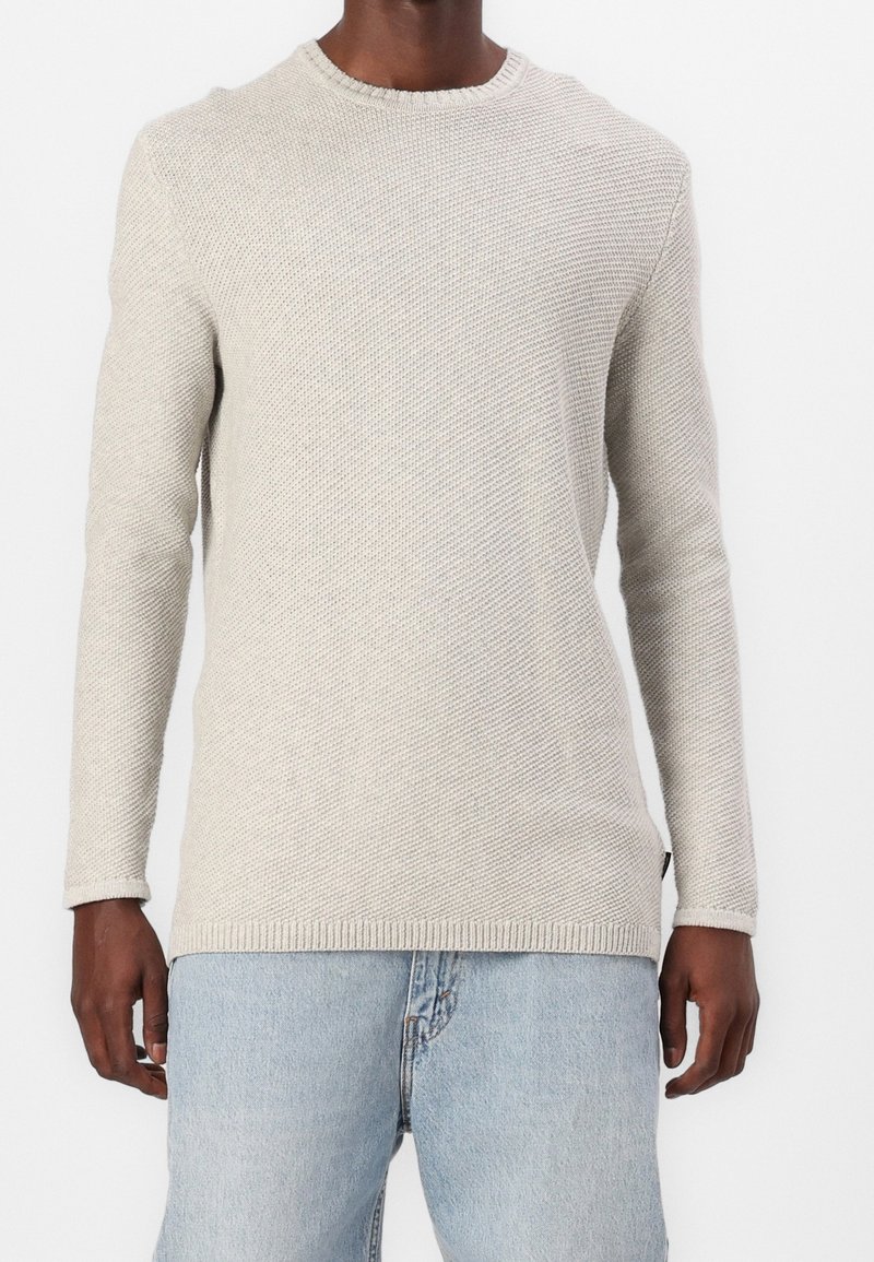 Light gray knitted sweater with a round neckline, long sleeves, and ribbed cuffs, featuring a textured pattern throughout.