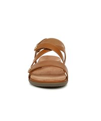 Brown leather slide sandals with three cross straps. Cushioned footbed and textured sole. Accented with metal hardware on one strap.