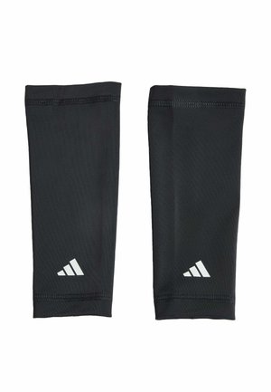 Paire de manchons noirs Adidas avec logo blanc Adidas près de la zone du poignet, affichée à plat sur fond blanc.