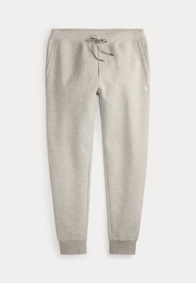 Pantalon de survêtement gris clair avec taille à cordon, poches latérales, poignets côtelés et petit logo brodé sur la cuisse droite.