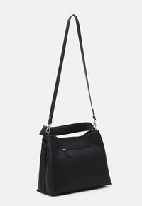 Black leather handbag with a structured shape, featuring a detachable shoulder strap, front zip pocket, and gold-tone hardware accents.