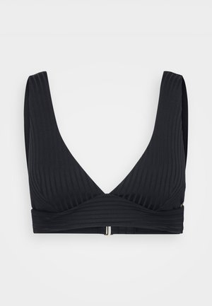 Black, ribbed soft cup bra with a V-neck design, broad straps, and a contrasting clasp at the back for closure.