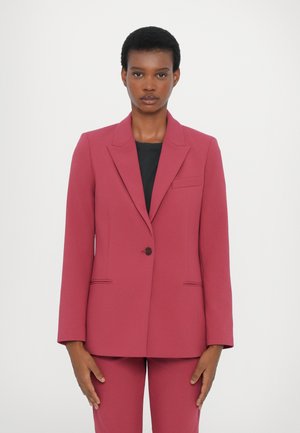 Fitted blazer in dark rose, made of smooth fabric. Features a single button, notch lapels, and front pockets. Paired with matching trousers.