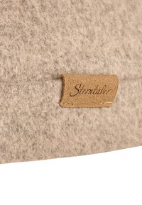 Gray felt textile with a textured finish, featuring a brown leather label stitched on, embossed with the brand name "Stentaller."