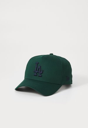 Green baseball cap with a structured crown, curved visor, and embroidered "LA" logo in navy. Soft fabric and subtle texture.