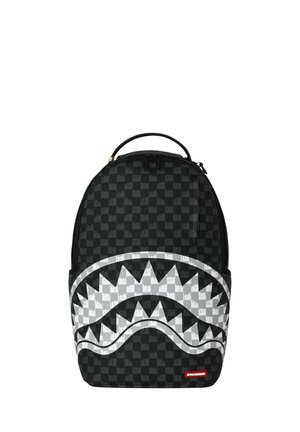 Zaino nero a quadri con grande motivo bianco a forma di bocca di squalo sul davanti e piccolo patch logo rosso in basso a destra.