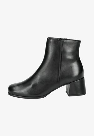 Botte de cheville en cuir noir avec un bout légèrement arrondi, un talon carré de hauteur intermédiaire et une texture lisse et brillante. Fermeture éclair sur le côté.