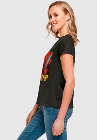 Black cotton t-shirt with short sleeves, featuring a colorful graphic print and text design on the front. Fitted shape, smooth texture.