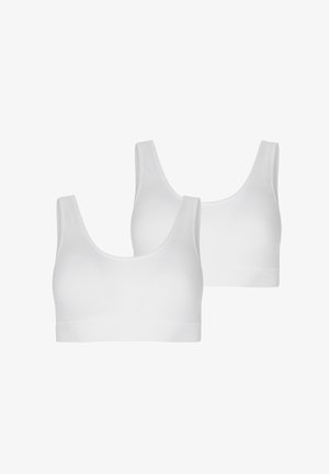 Hvide sports-bh'er med brede stropper, en rund udskæring og sømløst design. Blødt stof med en glat tekstur. To enheder vist.