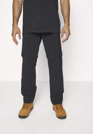 Black, lightweight cargo pants with zippered pockets, worn with tan hiking boots. Pants feature a convertible design for adjustable length.