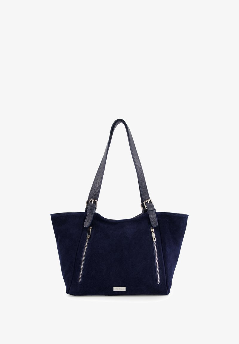 Navy suede tote bag with two zip pockets, dual textured straps, and metallic logo plate. Wide shape with soft, durable material.