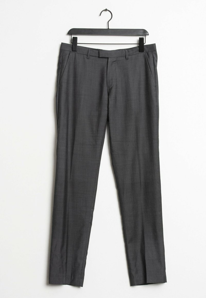 Pantalons gris ajustés en tissu légèrement texturé, avec un devant plat, des passants de ceinture et des poches latérales. Suspendus sur un cintre en métal noir.