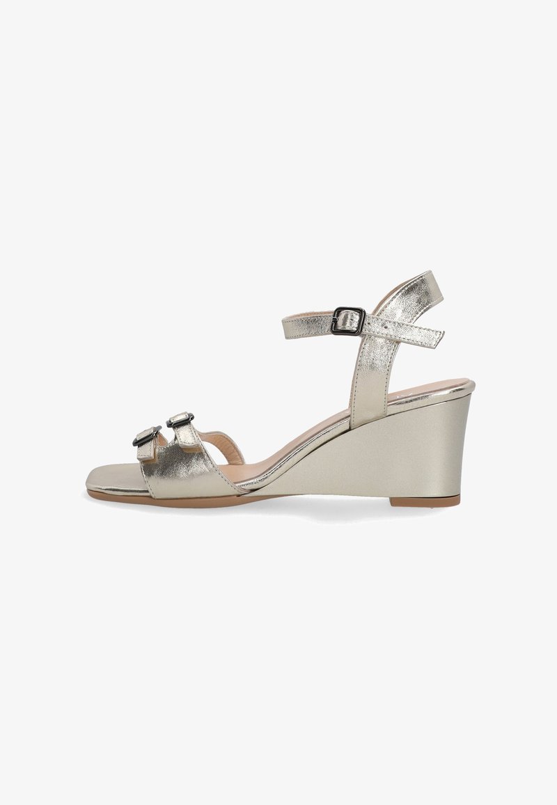 Metallic gold wedge sandals with ankle strap, featuring two front straps adorned with buckles, smooth texture, and open toe design.