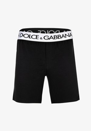 Schwarze Herrenboxershorts mit einem weißen Bund mit dem Schriftzug „Dolce & Gabbana“ in fetten schwarzen Buchstaben.