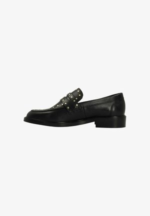 Schwarze Leder Slipper mit einem genoppten Riemen, abgerundeter Zehenpartie und niedrigem Blockabsatz. Glatte Textur mit minimalistischen Designdetails.