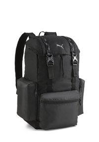 Zaino nero realizzato in tessuto testurizzato, dotato di più scomparti, spallacci regolabili e tasche laterali. Logo visibile sul davanti.