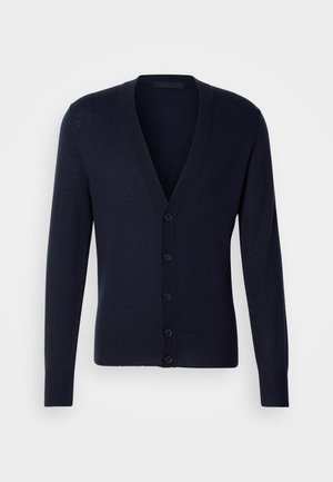 Sötétkék kardigán V nyakkal, bordás mandzsettákkal és szegéllyel. Hat elülső gombbal és sima kötött textúrával rendelkezik.