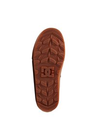Suela de zapato DC, material de goma, color marrón anaranjado, superficie texturizada con patrón de tracción, con el logo de DC en el centro.