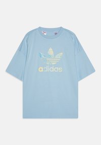 Gaiši zila kokvilnas T-krekls ar īsām piedurknēm, kas izceļas ar daudzkrāsainu Adidas trefoil logotipu un tekstu uz krūtīm.
