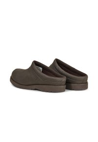 Brown leather clogs with a rounded toe, cushioned interior, and textured brown rubber sole, featuring side elastic for easy wear.