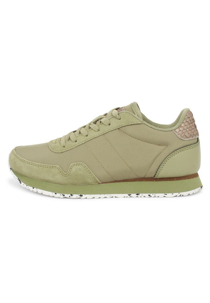 Light green sneakers made of leather and suede, featuring a textured heel accent, rubber sole with black speckles, and classic lace-up design.