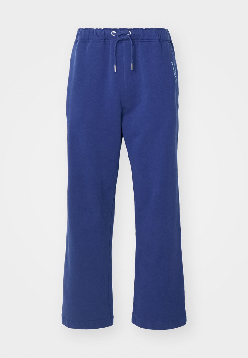 Blaue Sweatpants mit einem Kordelzugbund, lockerem Design, weicher Textur und weißen Logo-Details an der Seite.