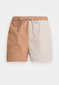 Kevyet shortsit, joissa on väriblokki-design ruskeana ja kermanvärisenä. Joustava vyötärönauha nyörillä säädettävää istuvuutta varten. Sileä pinta.