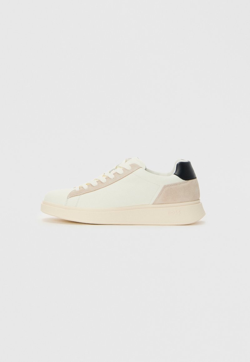 Sneaker cu vârf jos, de culoare albă murdară, cu accente de suede bej, tab epică neagră, design cu șireturi și o talpă groasă de crem.