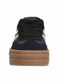 Sneaker nera con suede testurizzato e tessuto liscio, dotata di una spessa suola in gomma color tabacco e lacci neri. Accenti color cammello sui lati.