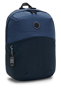 Navy blue backpack with a smooth texture, a rounded shape, and a lower dark panel. Features a circular logo and a black tag.