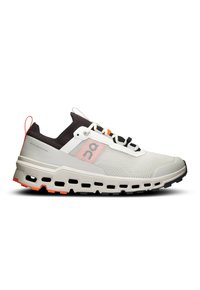 Chaussure de course légère conçue avec un tige en mesh blanc, des accents noirs, des détails orange, et une semelle rembourrée avec des sections découpées.
