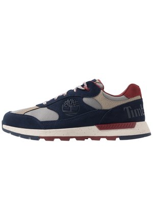 Navy blue suede sneakers with grey mesh panels, red accents, and a white speckled sole. Features a Timberland logo on the side.