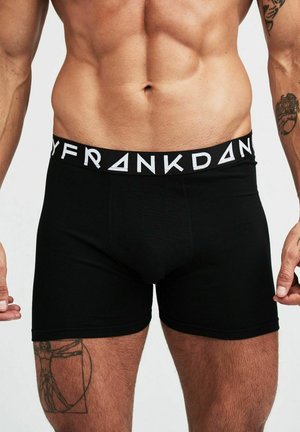 Svarta boxershorts i stretchig tyg med en enfärgad design. Har en märkes-elastisk midjeband i vitt med geometriska accenter.