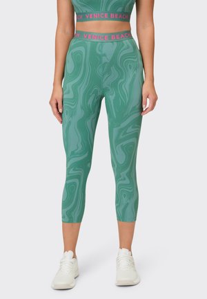 Green marble-patterned leggings with a high waistband, featuring "VENICE BEACH" in pink lettering, made of stretchy, smooth fabric.