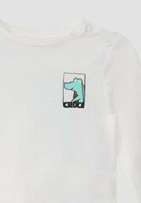 Witte langesleeve shirt van katoen, met een kleurrijke cartoon krokodil graphic en zwarte tekst "CROCO" onder het beeld.