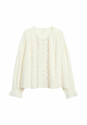 Kremowa bluzka z długim rękawem, zapinana na guziki z przodu, z delikatną kwiatową haftowaną dekoracją wzdłuż środka, falbankami przy mankietach oraz subtelną falbaną przy dekolcie.