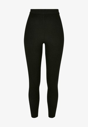 Leggings neri a coste con vita alta. Realizzati in un tessuto testurizzato, hanno una forma aderente con una finitura liscia e senza cuciture visibili.