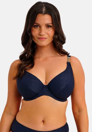 Marineblauer BH mit einem strukturierten geometrischen Muster, Unterbrustbügel und verstellbaren Trägern mit goldfarbenen Hardware-Akzenten.