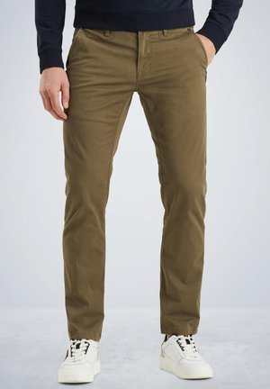 Khaki chinos made of cotton, slim fit, featuring front pockets, a zip fly, and worn with white sneakers. Smooth texture and consistent color.