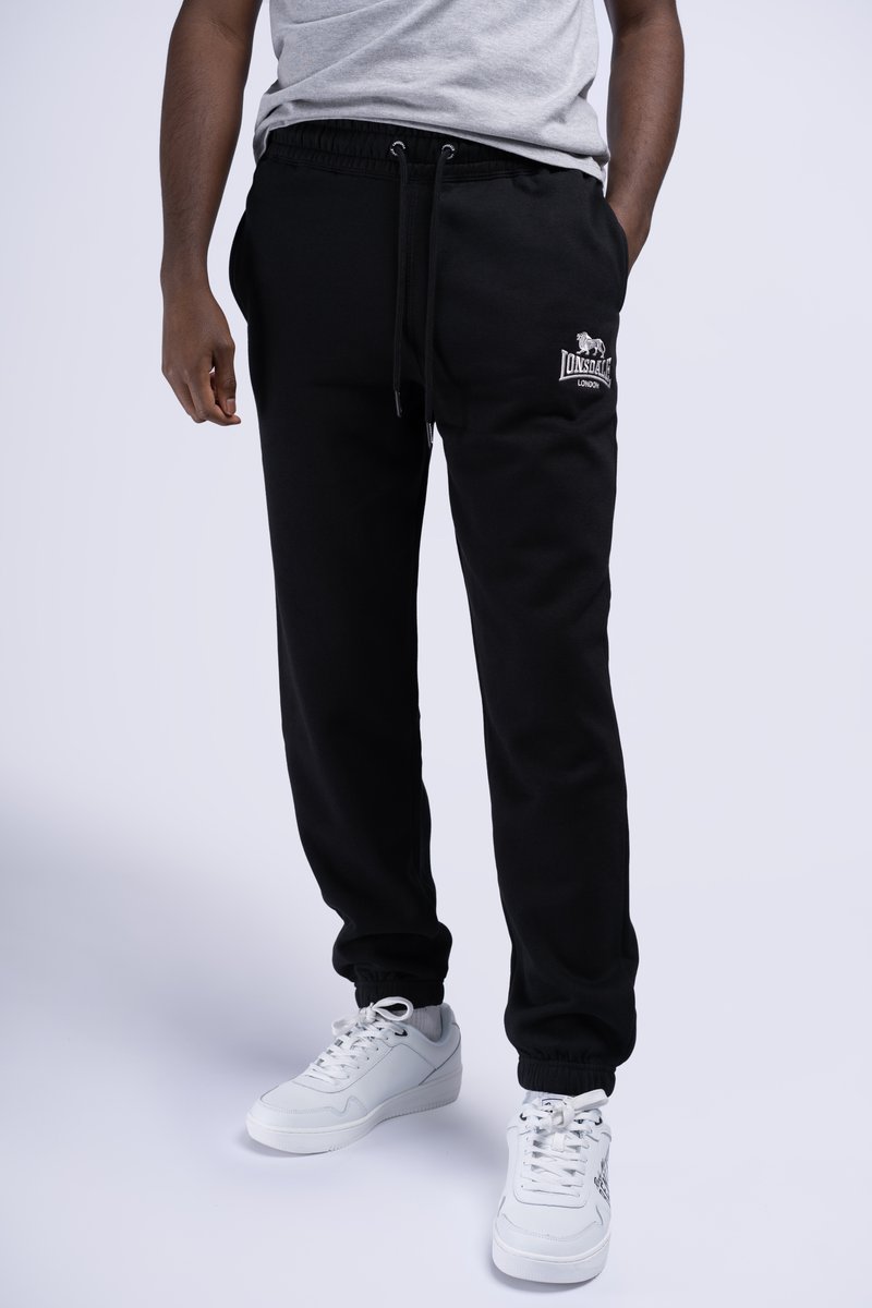 Black jogger pants made of soft fabric, featuring an elastic waistband with drawstring and an embroidered logo on the left hip.
