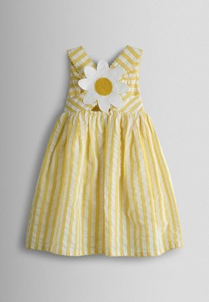 Žluté pruhované šaty s aplikací kopretiny na živůtku. Mají volánkové ramínka a rozšířenou sukni. Texturovaná bavlněná látka.
