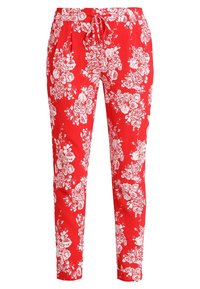 Rode tapse broek met witte bloemenprint, elastische tailleband en een trekkoord aan de voorkant.